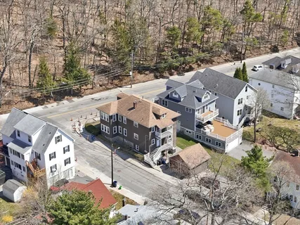 an aerial view of a house with large trees