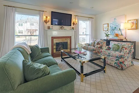 a living room with furniture fireplace and a flat screen tv