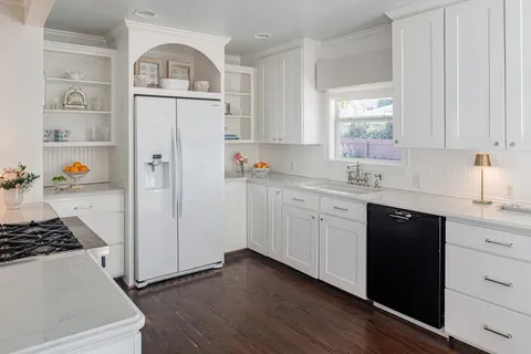 a kitchen with stainless steel appliances a refrigerator sink and cabinets