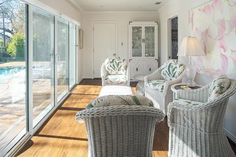 a bedroom with furniture and a large window