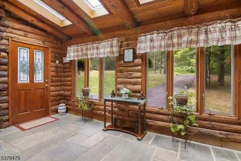 a backyard of a house with barbeque oven table and chairs