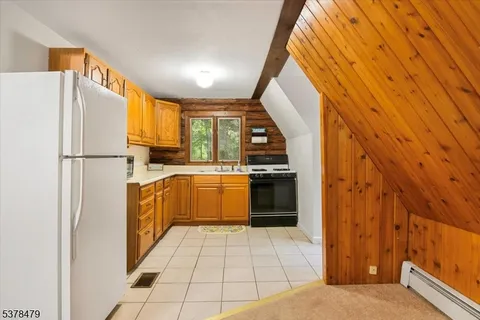 a kitchen with refrigerator and cabinets