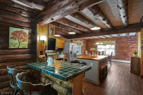 a kitchen with sink stove and dining table