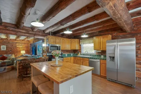 a kitchen with stainless steel appliances granite countertop a sink a stove and a refrigerator