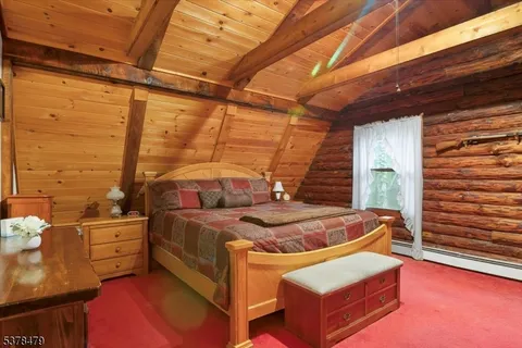 a bed room with a bed and a chair