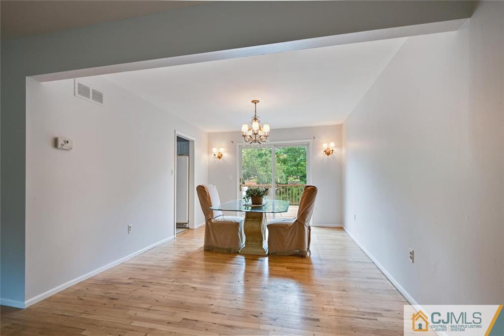 4 Revock Road East Brunswick, NJ 08816 - Photo 11 of 28 a dining room with furniture a chandelier and wooden floor