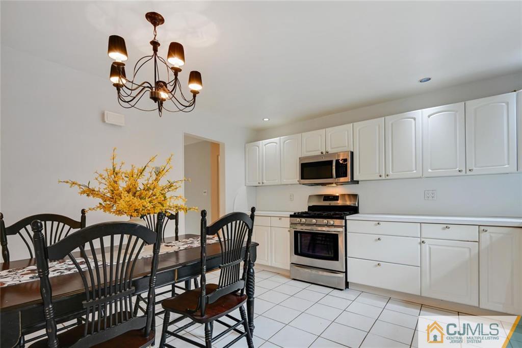 4 Revock Road East Brunswick, NJ 08816 - Photo 13 of 28 a kitchen with a table chairs and a stove
