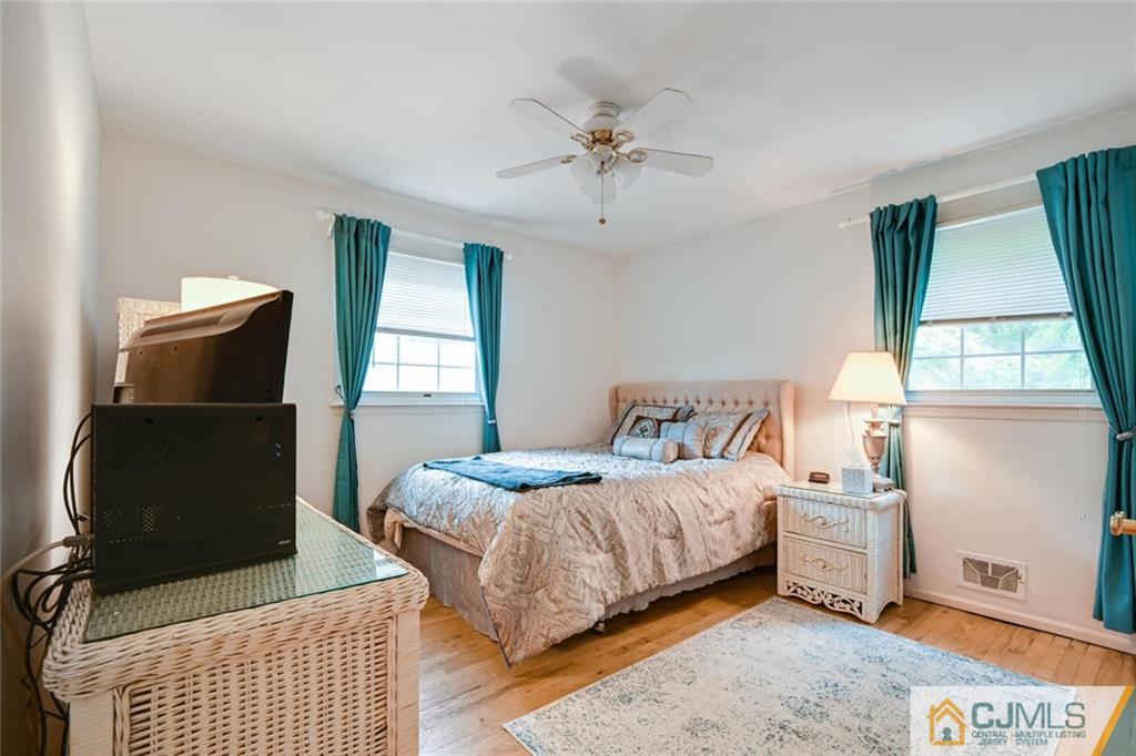 4 Revock Road East Brunswick, NJ 08816 - Photo 19 of 28 a bedroom with a bed and wooden floor