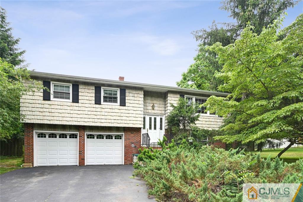 4 Revock Road East Brunswick, NJ 08816 - Photo 3 of 28 a front view of a house with a garden