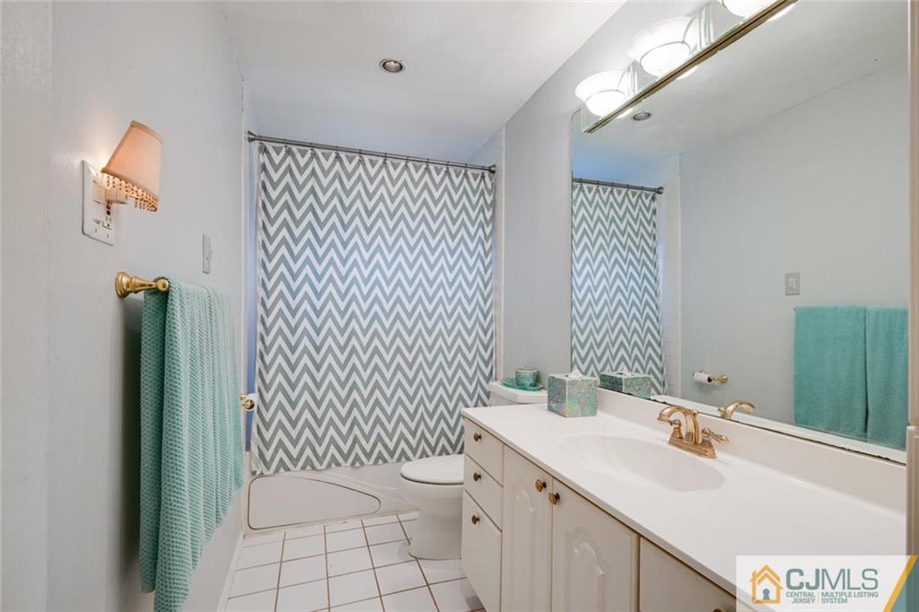 4 Revock Road East Brunswick, NJ 08816 - Photo 21 of 28 a bathroom with a sink a toilet and mirror