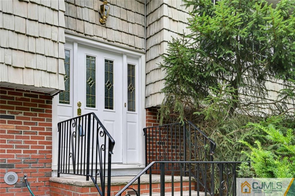 4 Revock Road East Brunswick, NJ 08816 - Photo 4 of 28 a view of a brick house with wooden fence and large windows