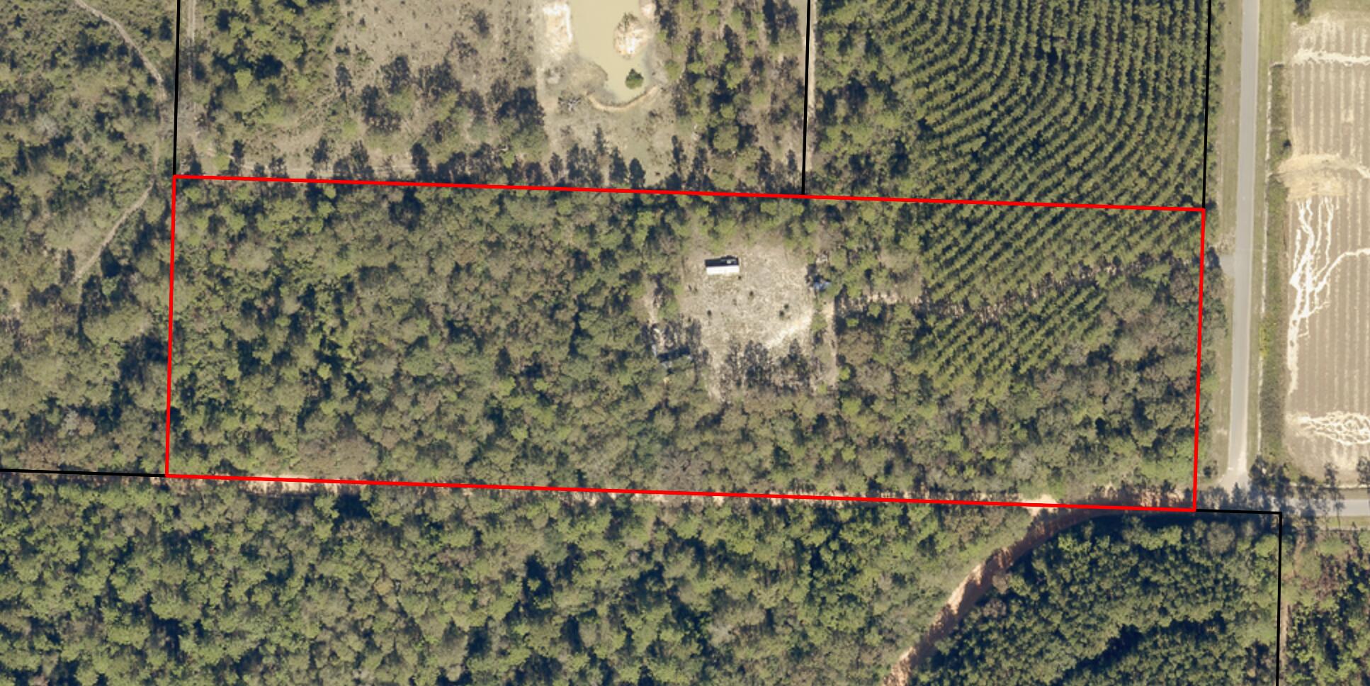 6221 County Line Road Baker, FL 32531 - Photo 15 of 16 a small yard and flowers