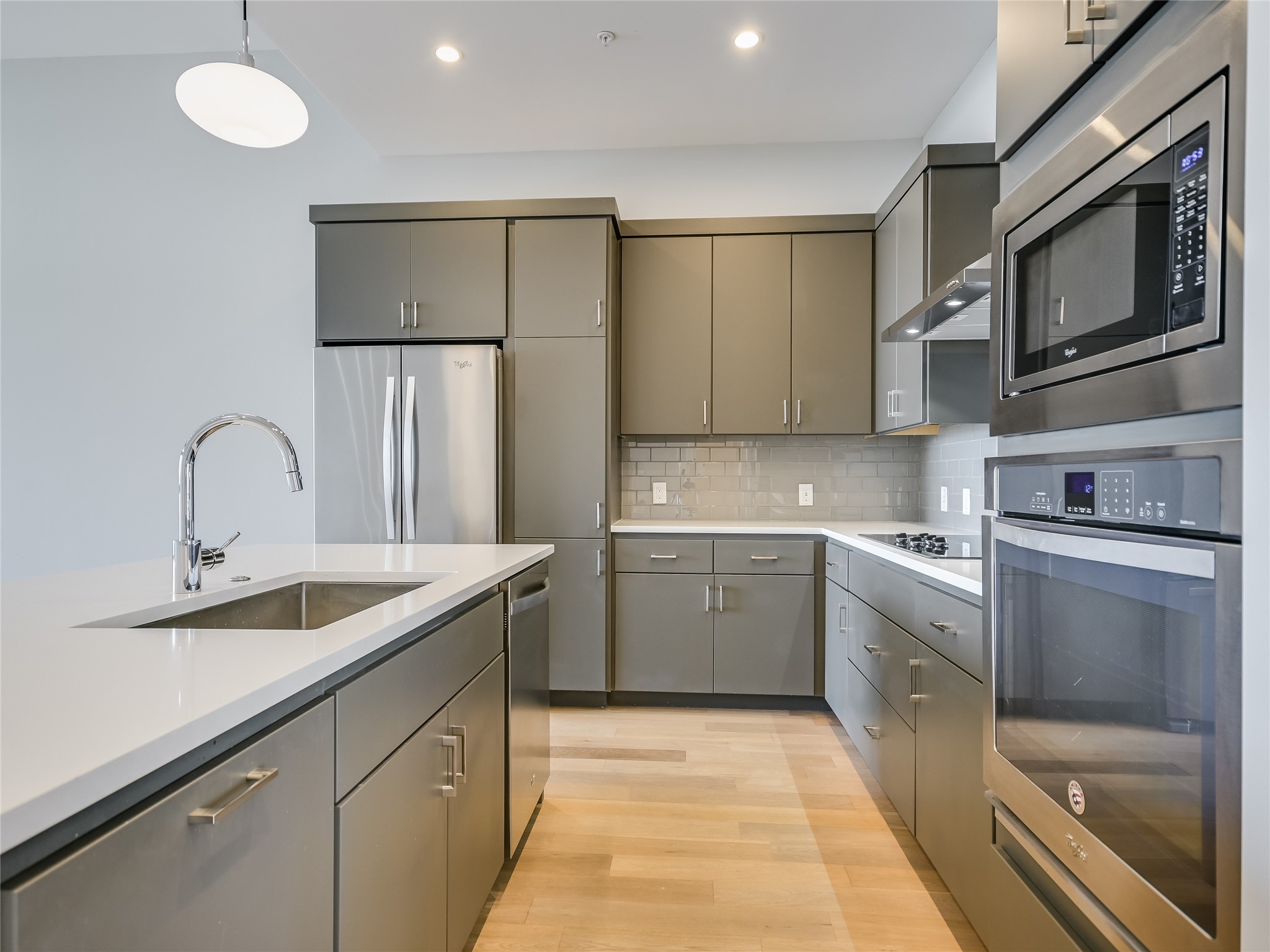 5921 Hiline Road, Unit 2402 Austin, TX 78734 - Photo 7 of 31 Kitchen also features ample cabinet storage, large single basin sink, Groehe water faucet, and a convenient pull-out trash drawer.