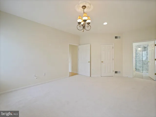 a view of empty room with wooden floor and fireplace