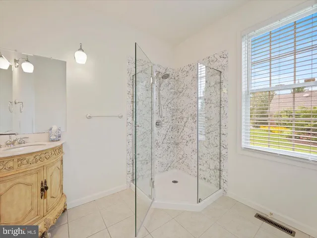 a view of empty room with wooden floor and fireplace