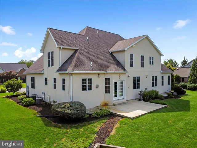 a front view of a house with a garden and plants