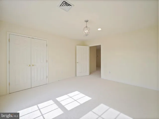 a spacious bathroom with a tub shower and windows