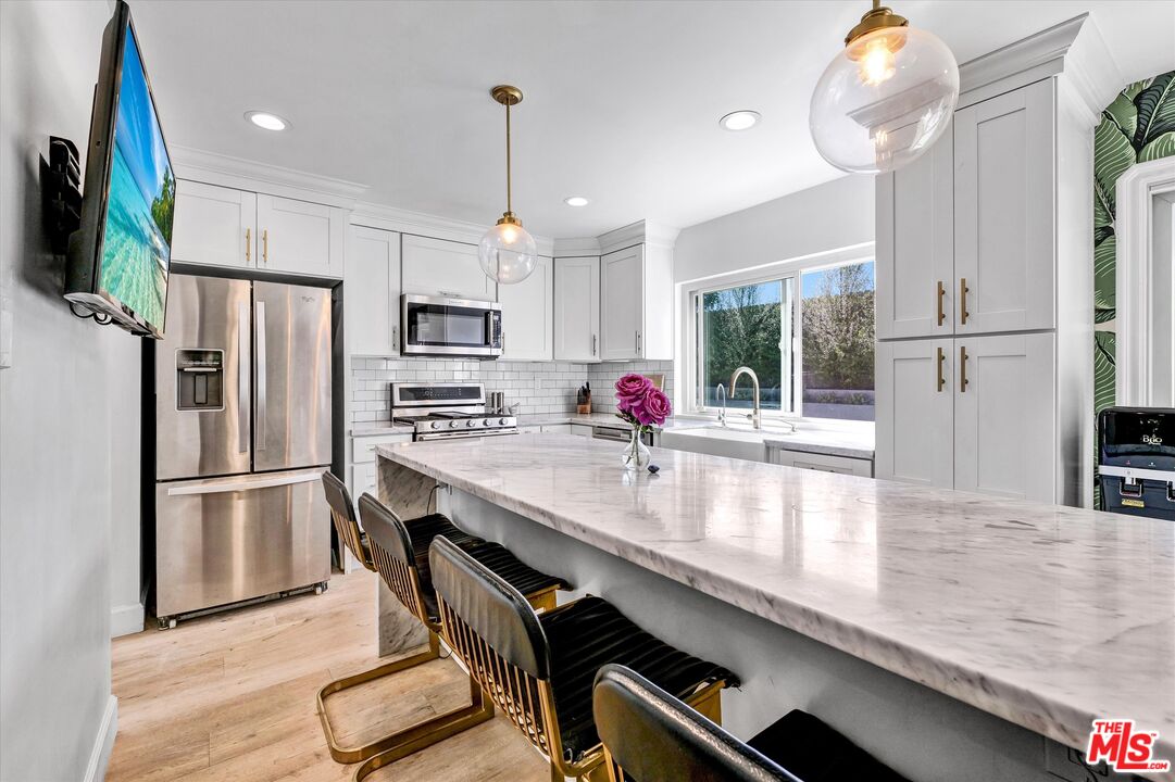 5101 Keli Court Los Angeles, CA 90066 - Photo 12 of 29 a kitchen with kitchen island a counter appliances cabinets and a counter top space