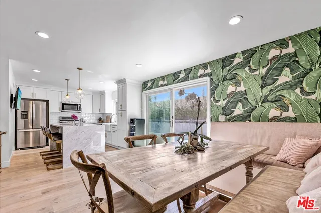 a view of a dining room with furniture and a floor to ceiling window