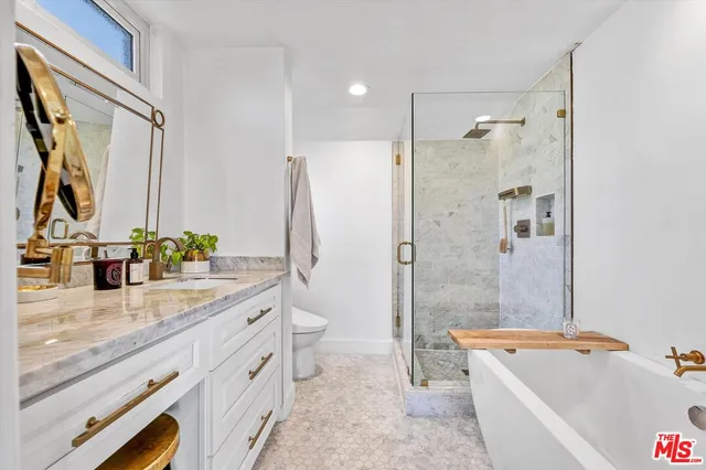 a bathroom with a granite countertop tub sink toilet and shower