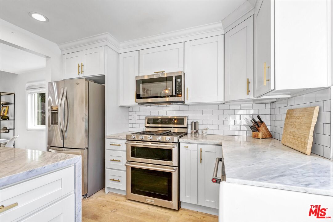 5101 Keli Court Los Angeles, CA 90066 - Photo 9 of 29 a kitchen with stainless steel appliances granite countertop a stove a refrigerator and a microwave