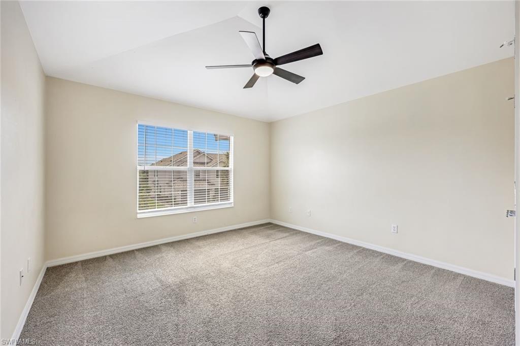 16162 Ravina Way, Unit 65 Naples, FL 34110 - Photo 12 of 22 a view of an empty room with a window