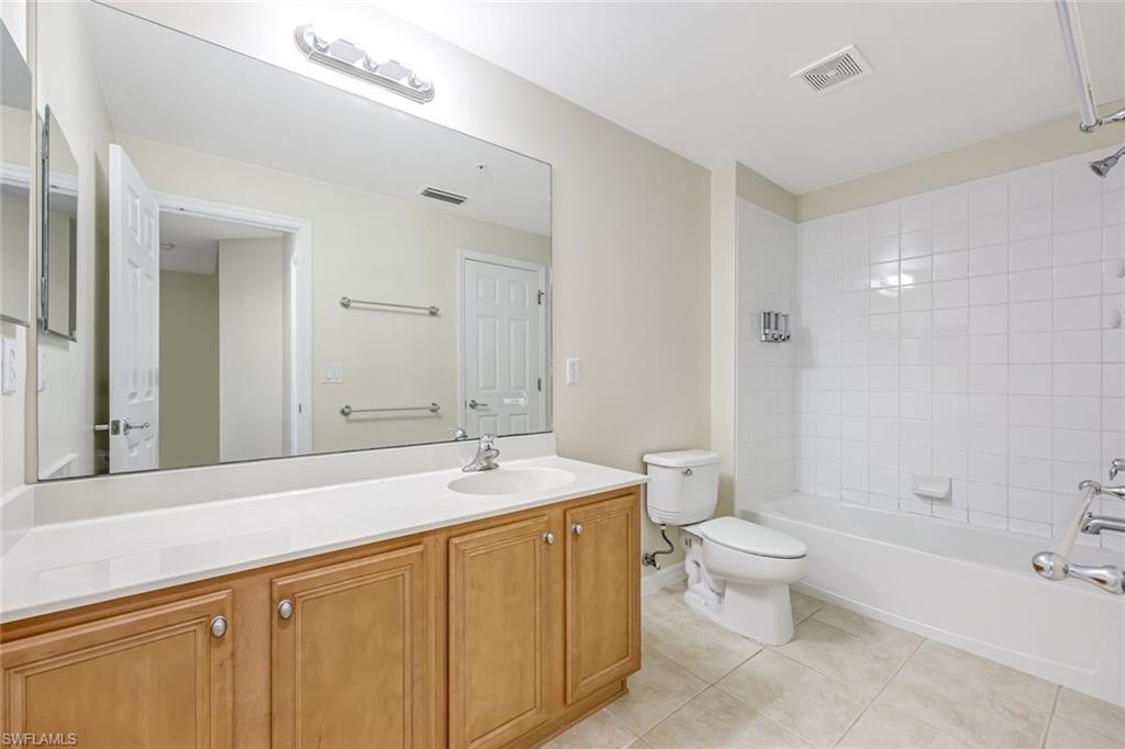 16162 Ravina Way, Unit 65 Naples, FL 34110 - Photo 13 of 22 a spacious bathroom with a bathtub shower sink mirror and toilet