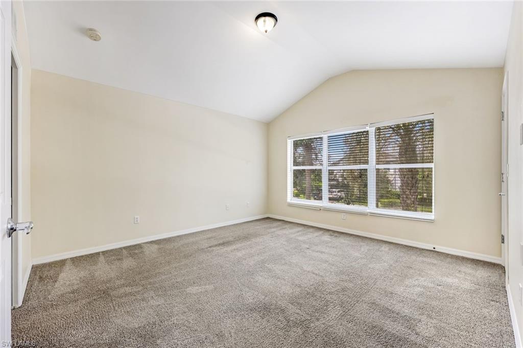 16162 Ravina Way, Unit 65 Naples, FL 34110 - Photo 16 of 22 an empty room with a window