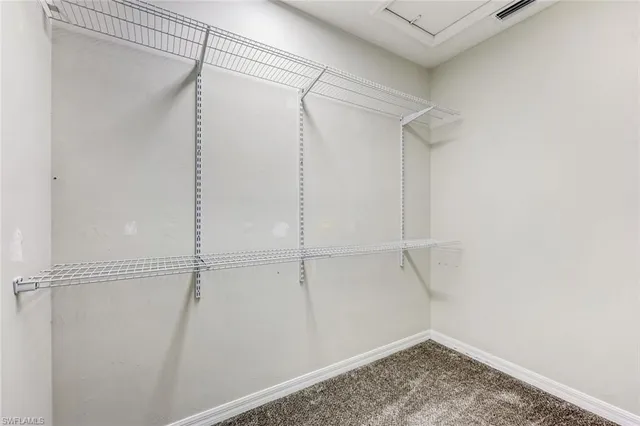 a view of an empty room and kitchen