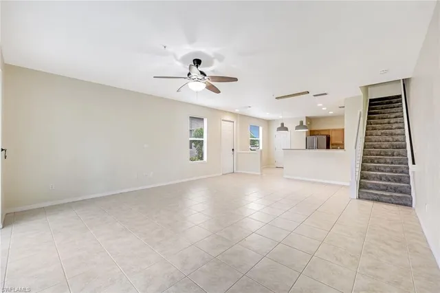 a view of a livingroom with furniture and chandelier fan
