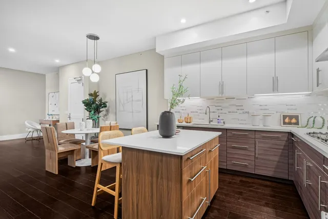 a kitchen with a table chairs sink and cabinets