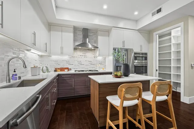 a kitchen with stainless steel appliances granite countertop a sink and cabinets