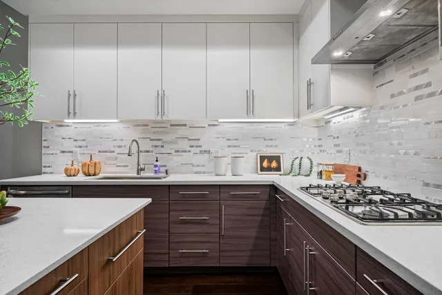 a kitchen with stainless steel appliances a stove a sink and cabinets