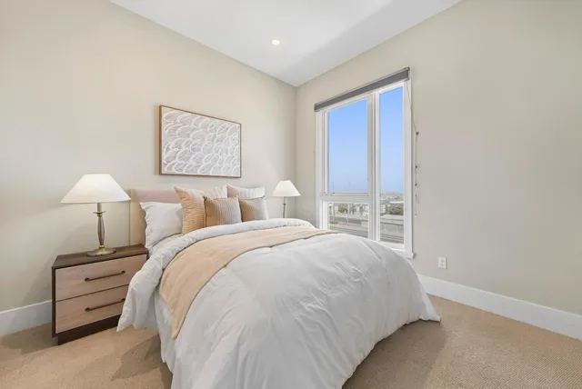 a bed room with a bed and a night stand