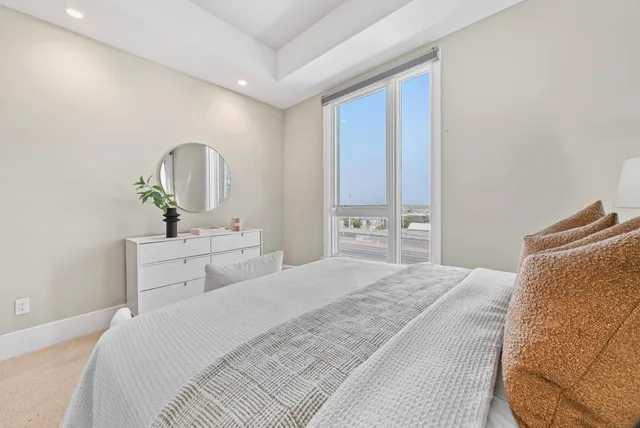 a bedroom with a bed and a mirror