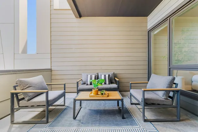 a backyard of a house with outdoor seating