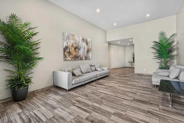 a living room with furniture and a potted plant
