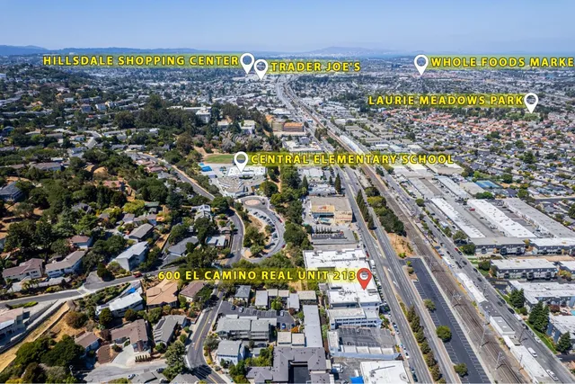 a view of a brick house with potted plants