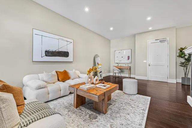 a living room with furniture and wooden floor