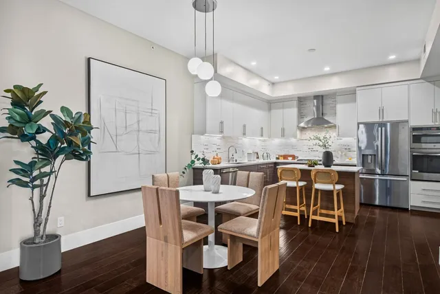 a view of a dining room with furniture and wooden floor