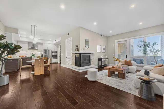 a living room with furniture wooden floor and a fireplace
