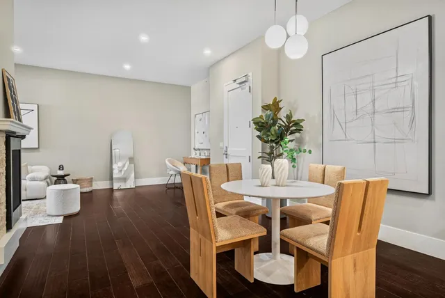 a dining room with furniture and wooden floor