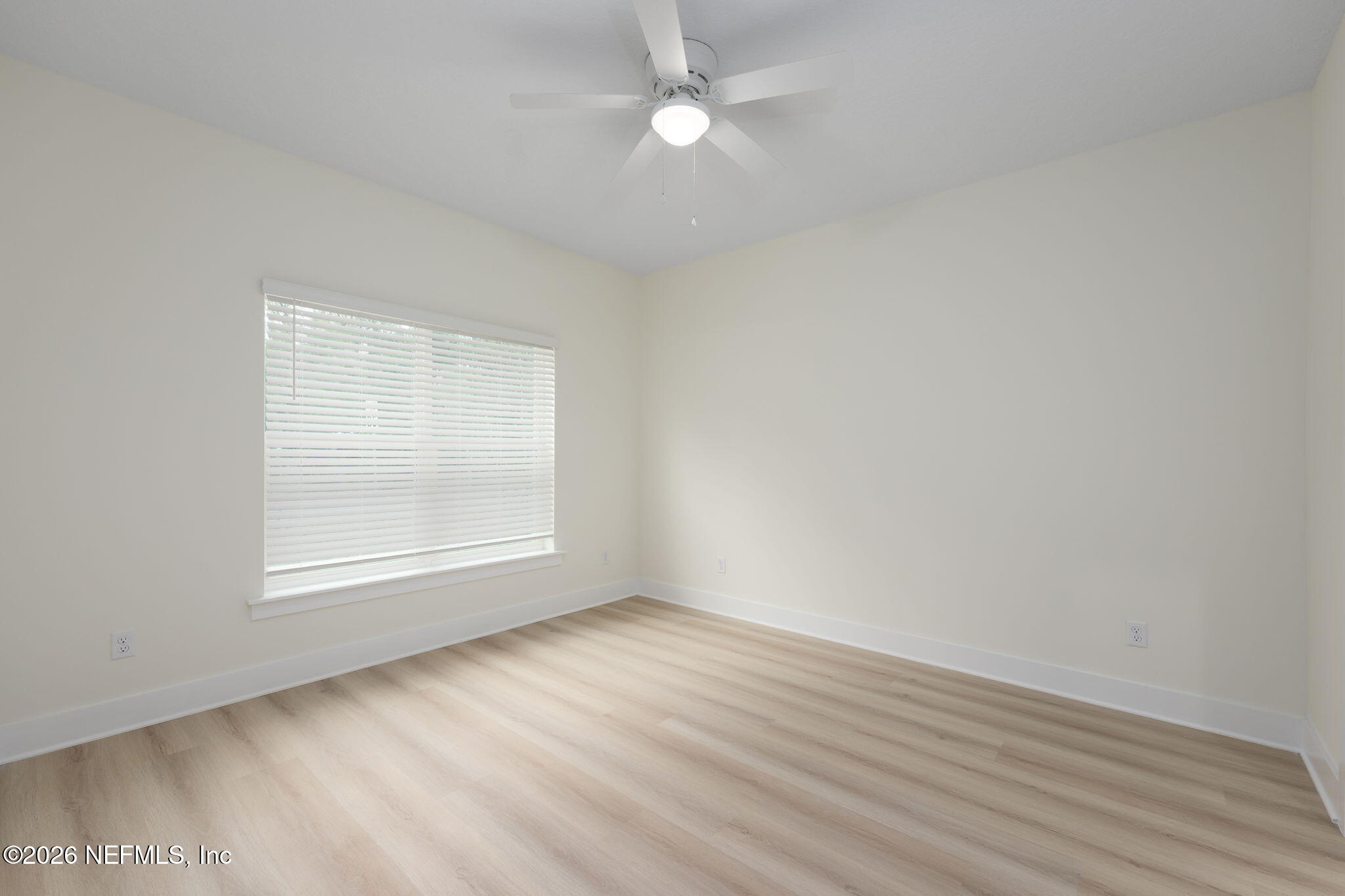 688 Madeore Street St. Augustine, FL 32084 - Photo 12 of 28 an empty room with wooden floor and windows