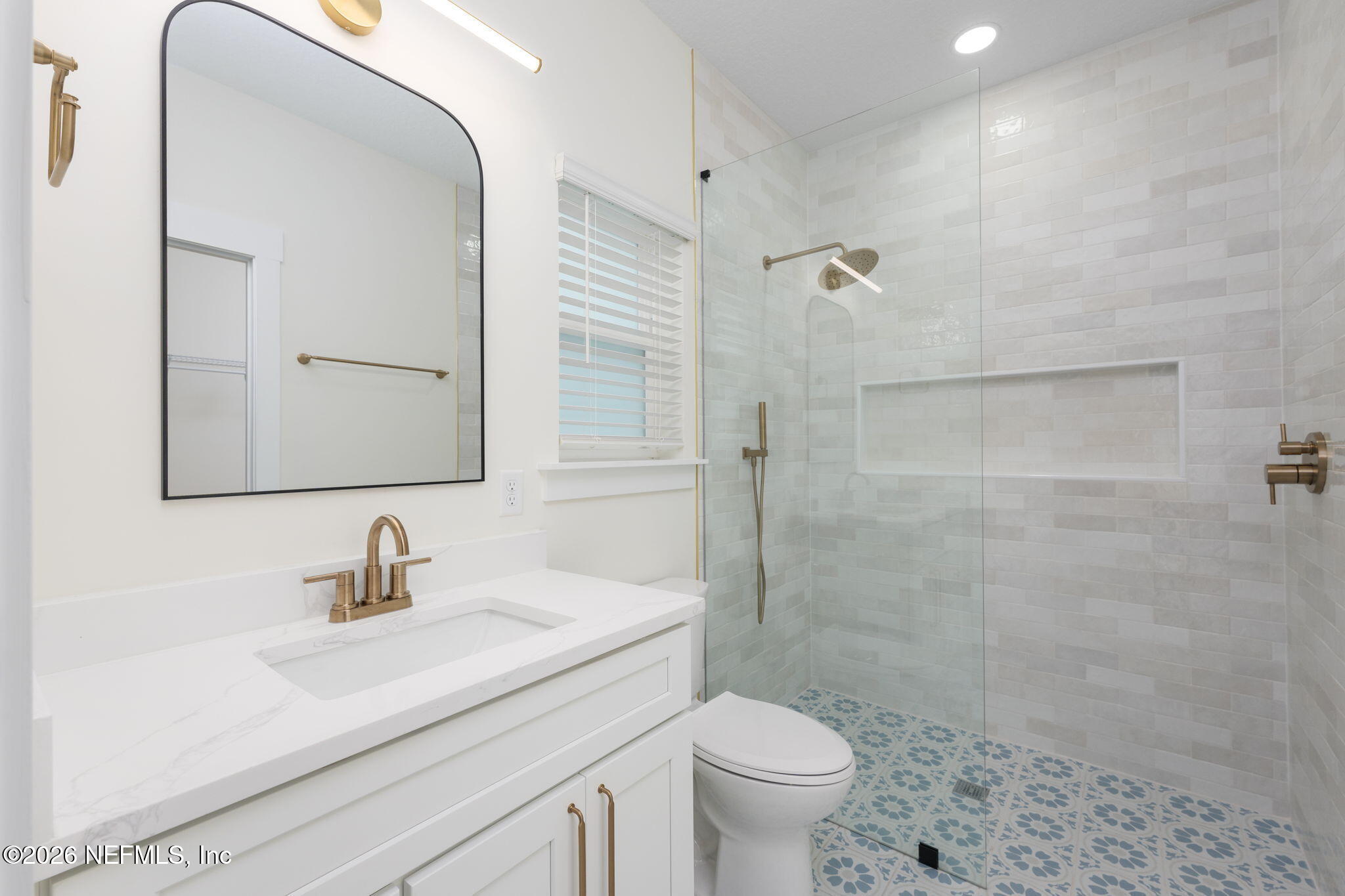 688 Madeore Street St. Augustine, FL 32084 - Photo 14 of 28 a bathroom with a sink a toilet and shower