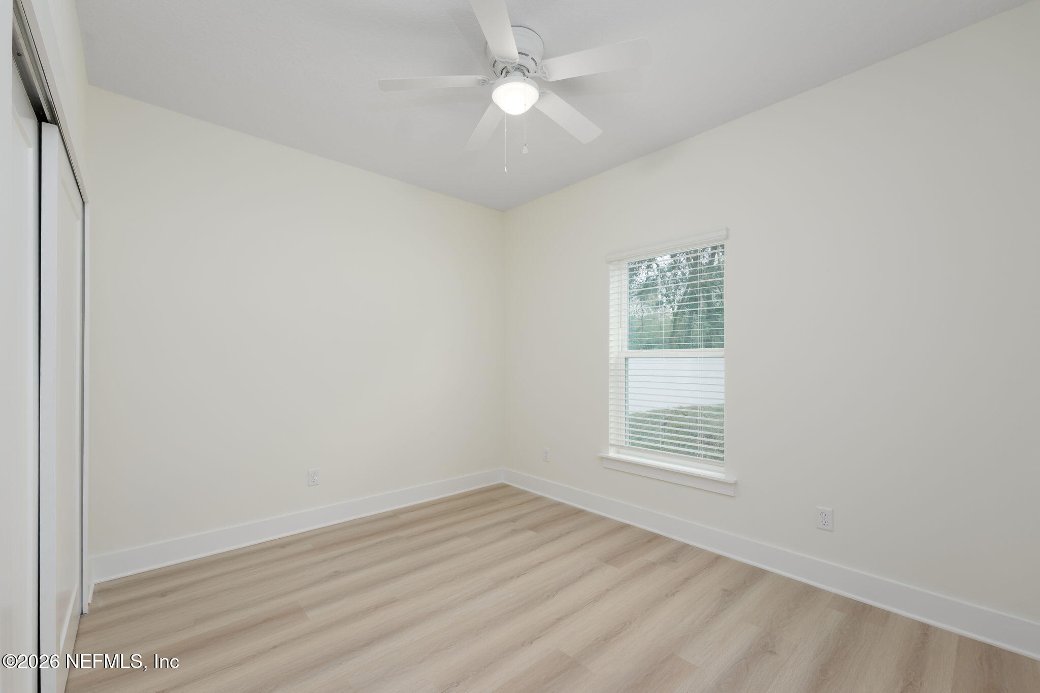 688 Madeore Street St. Augustine, FL 32084 - Photo 18 of 28 wooden floor in an empty room with a window
