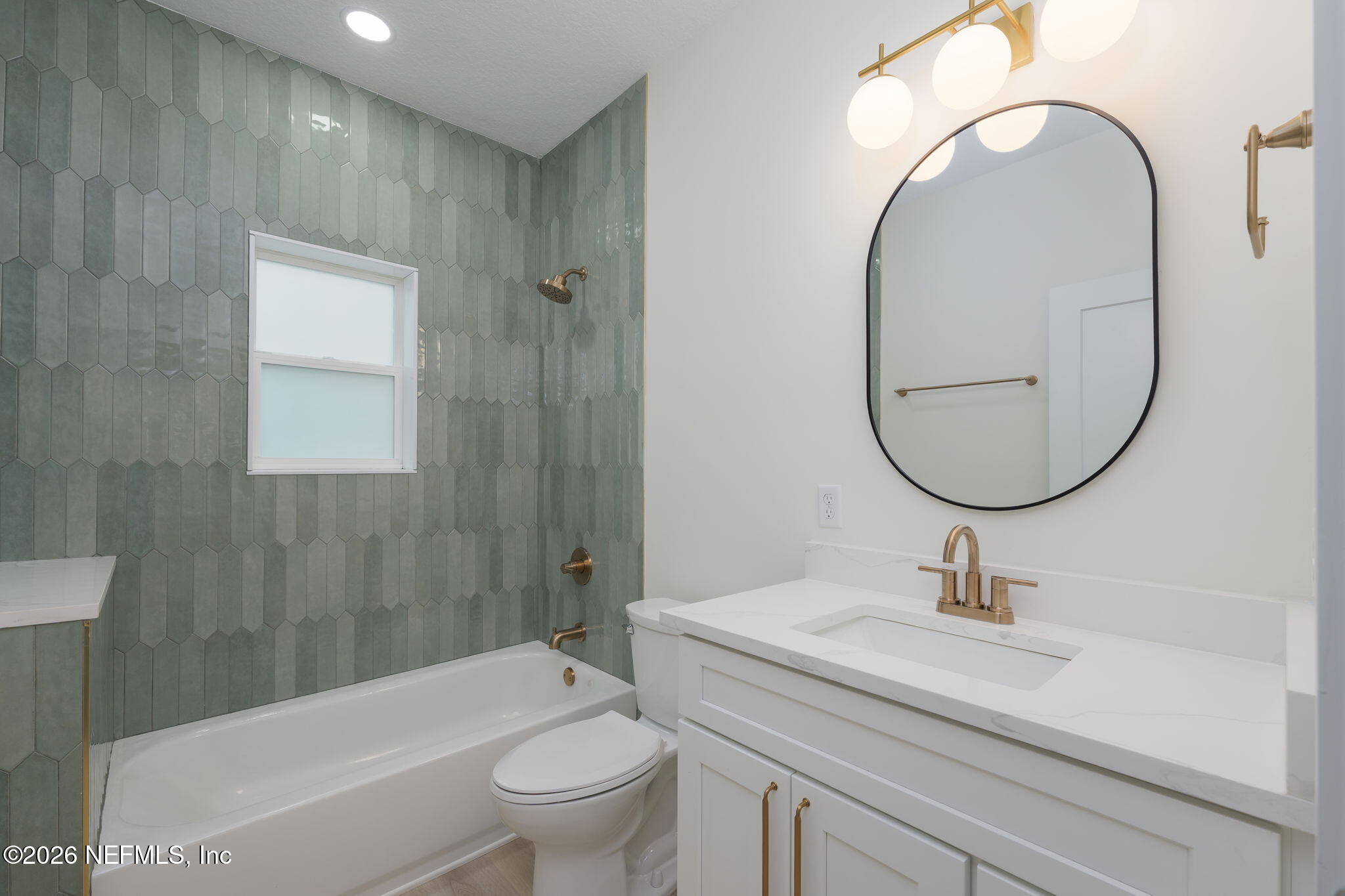 688 Madeore Street St. Augustine, FL 32084 - Photo 20 of 28 a bathroom with a sink a toilet and a mirror