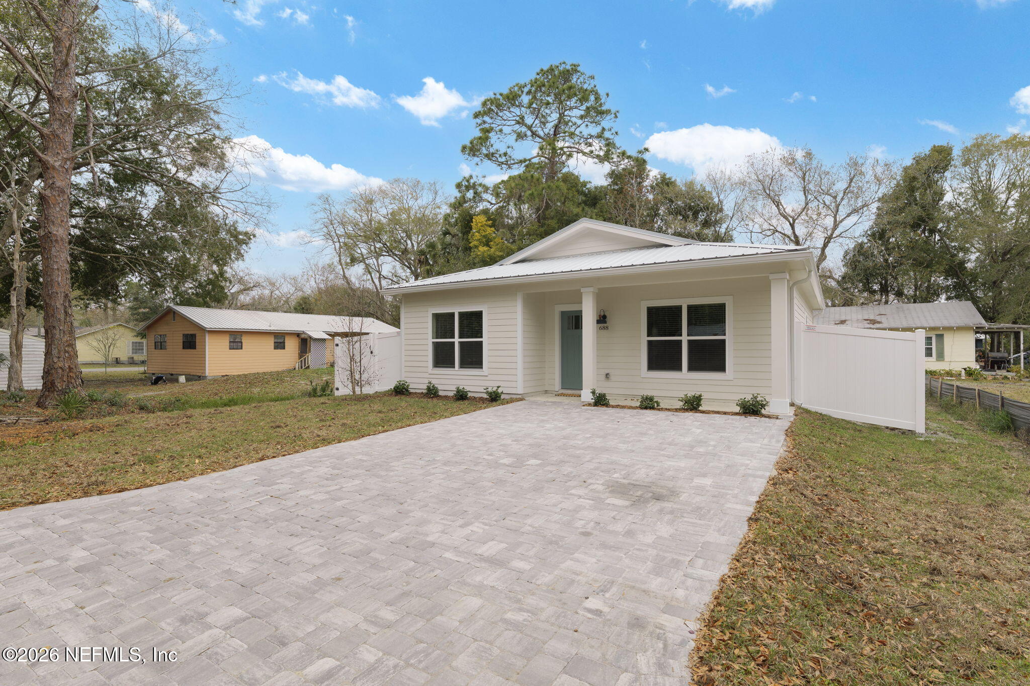 688 Madeore Street St. Augustine, FL 32084 - Photo 3 of 28 a front view of a house with a yard and garage