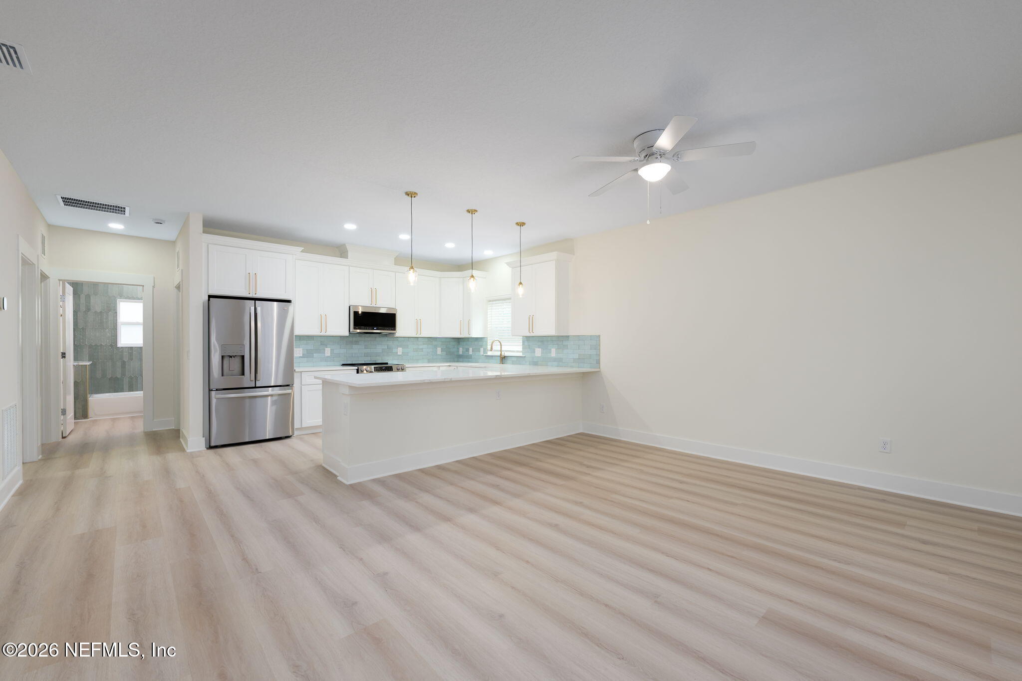 688 Madeore Street St. Augustine, FL 32084 - Photo 4 of 28 a large kitchen with kitchen island a sink stainless steel appliances and cabinets