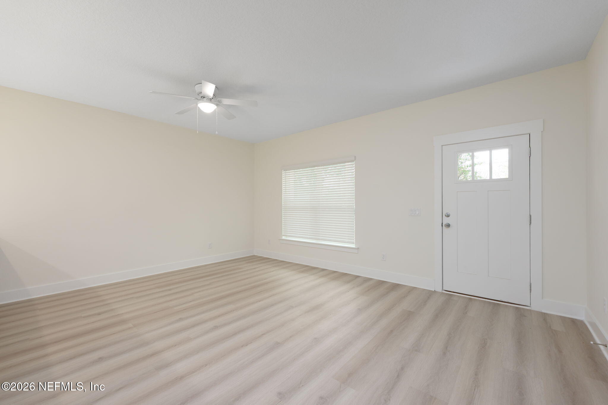 688 Madeore Street St. Augustine, FL 32084 - Photo 5 of 28 an empty room with wooden floor and windows
