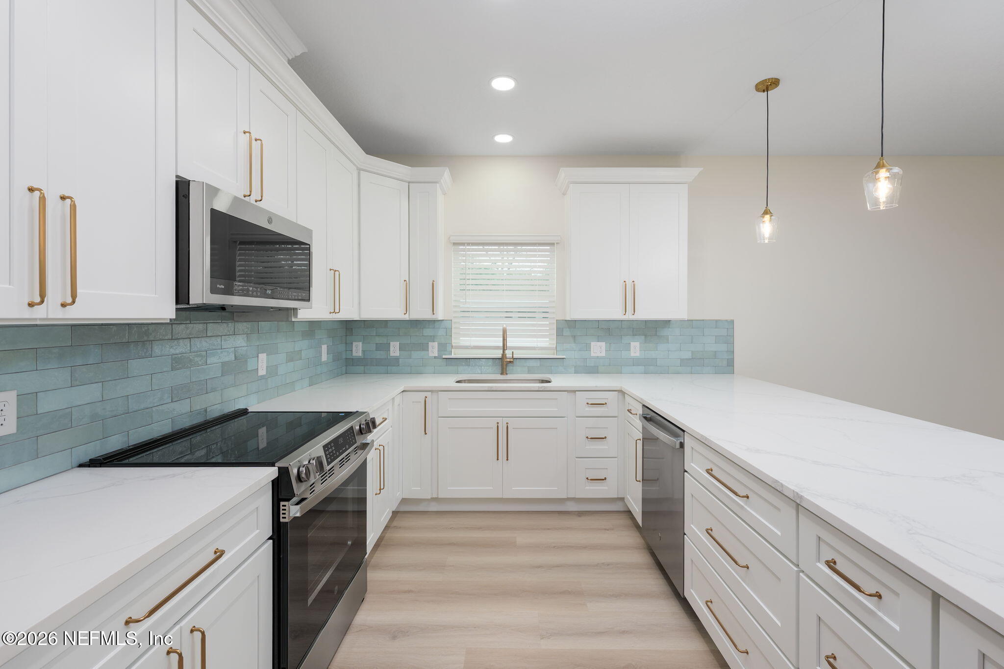 688 Madeore Street St. Augustine, FL 32084 - Photo 8 of 28 a kitchen that has a sink and a stove in it